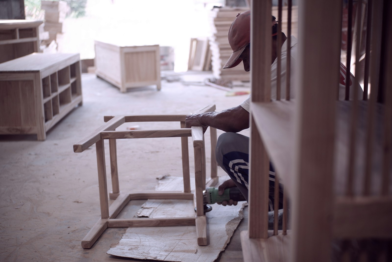 person in black shirt sitting on brown wooden chair