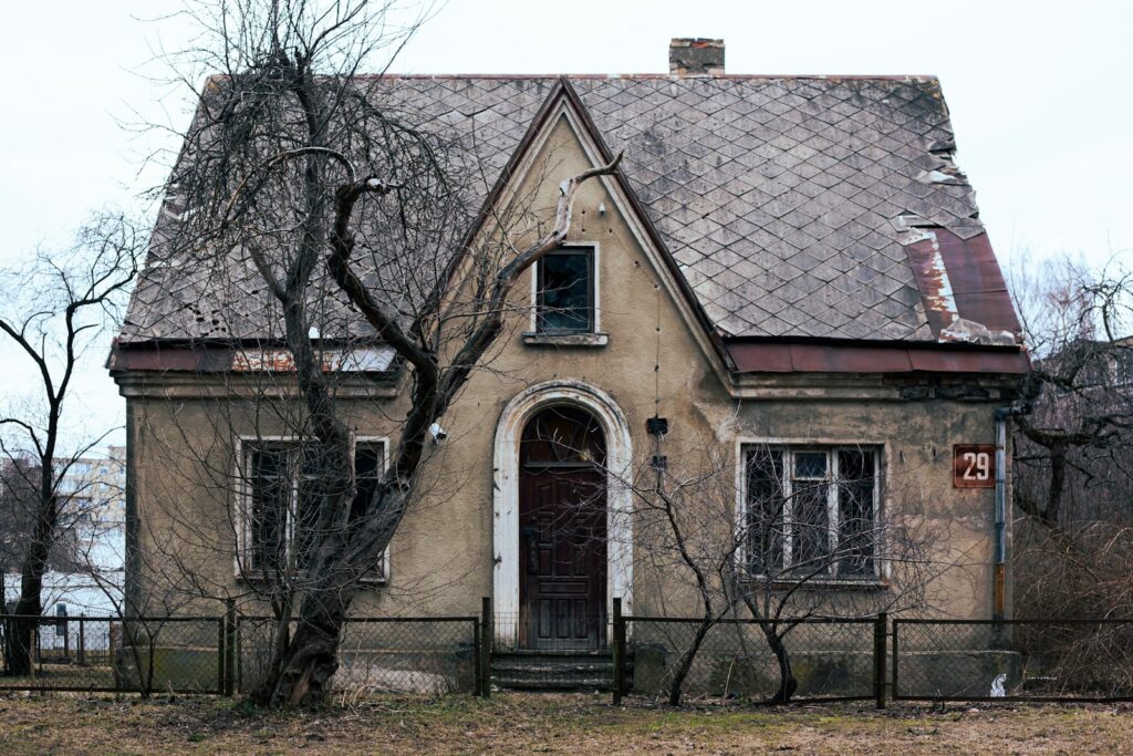 an old house with a fence around it
