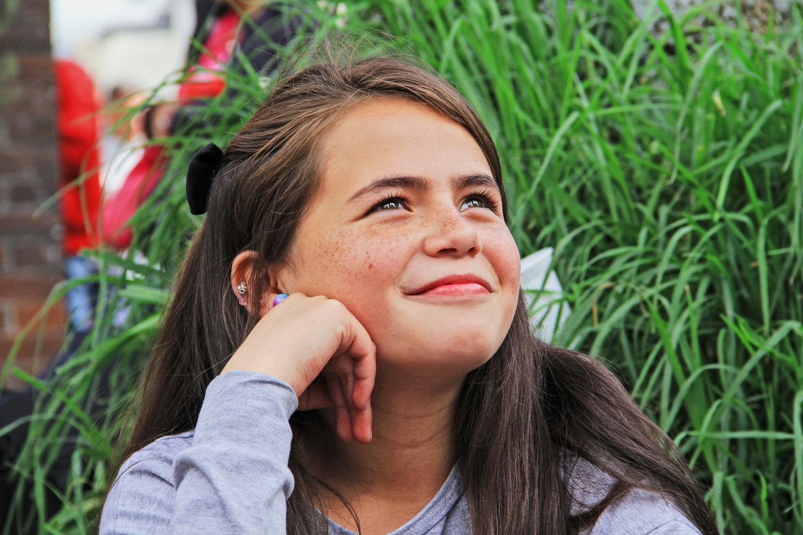 girl sitting looking up while smiling