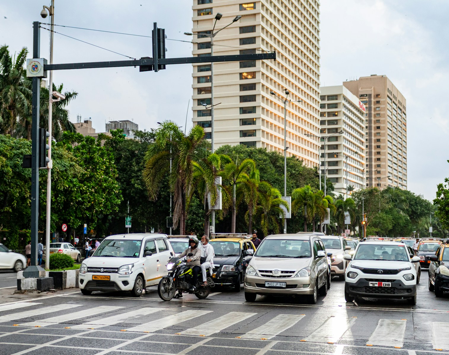 Cars and traffic are seen near tall buildings.