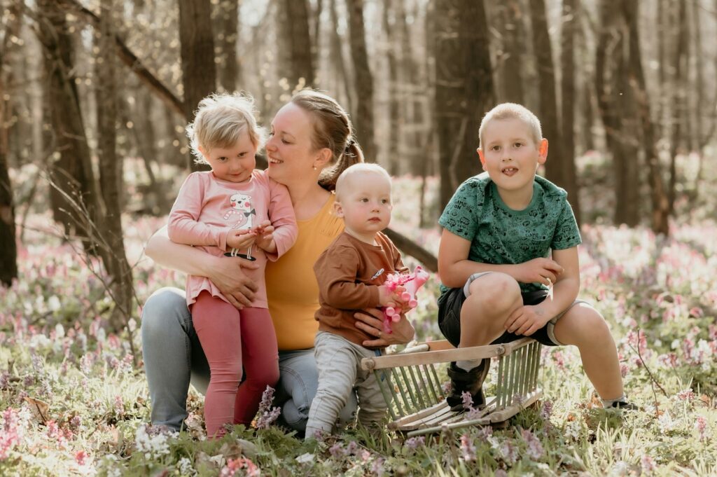 a group of people sitting in a field of flowers