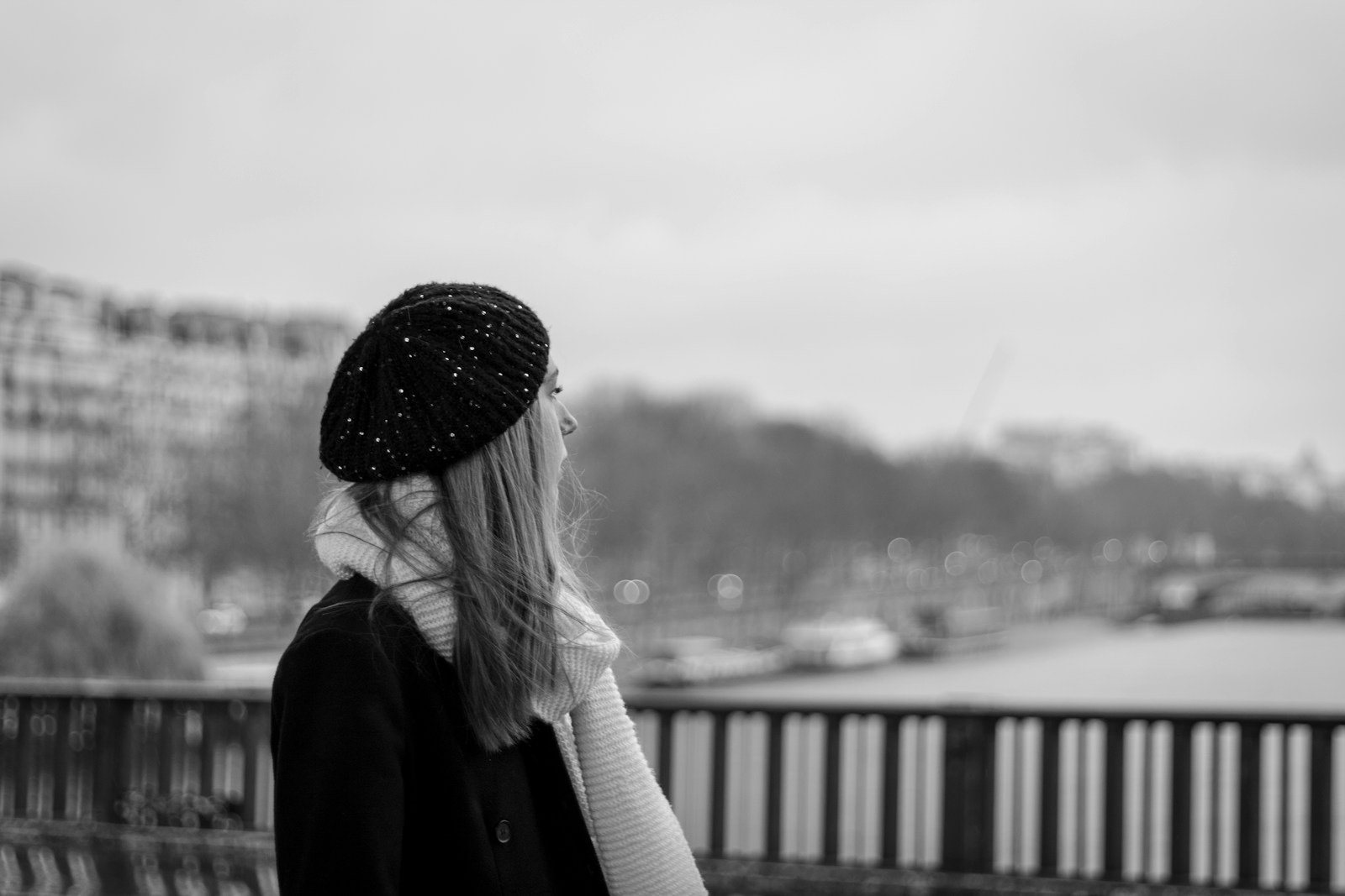 a woman with long hair wearing a hat and scarf