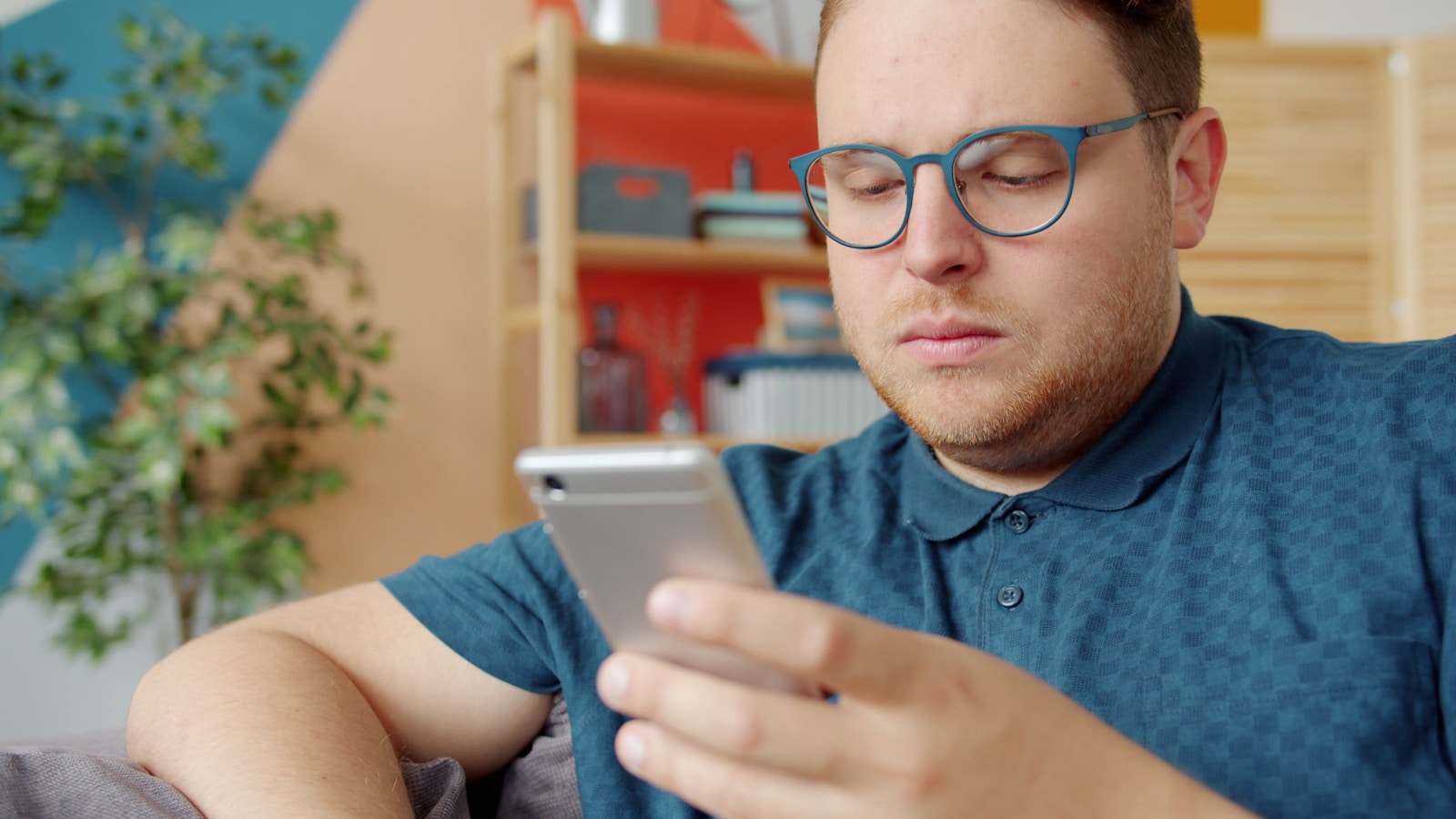 Man wearing glasses looking at his smartphone
