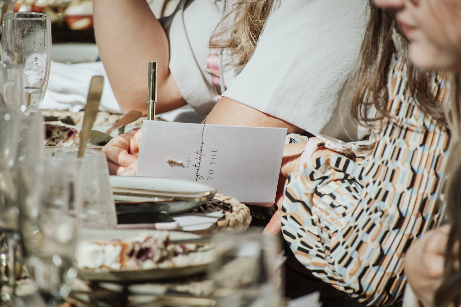 woman in white shirt holding pen and white paper