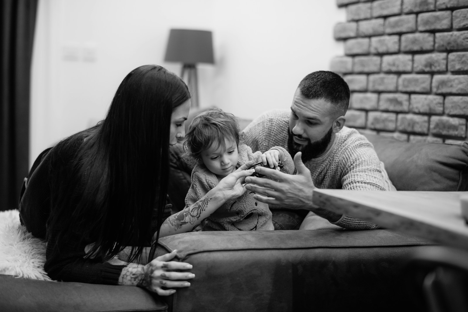 a man, woman and child sitting on a couch