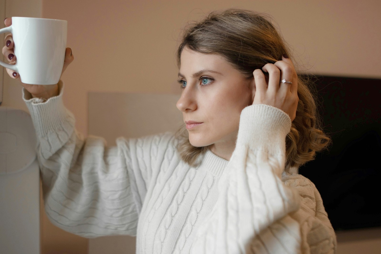 woman in white turtleneck sweater