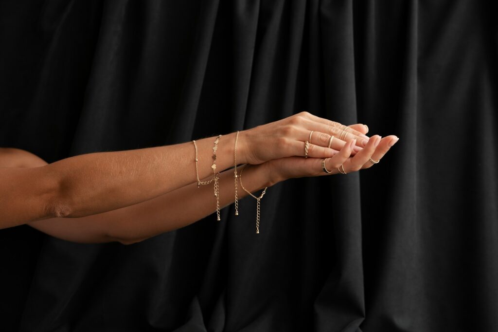 A woman in a black dress holding her hands together