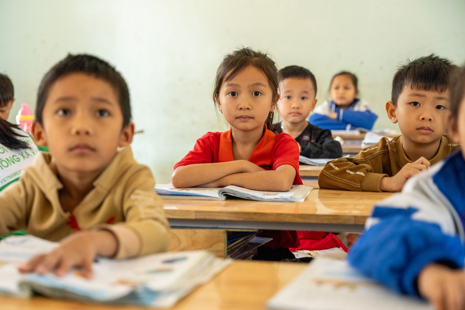 Young students focused and engaged while learning in a classroom environment.