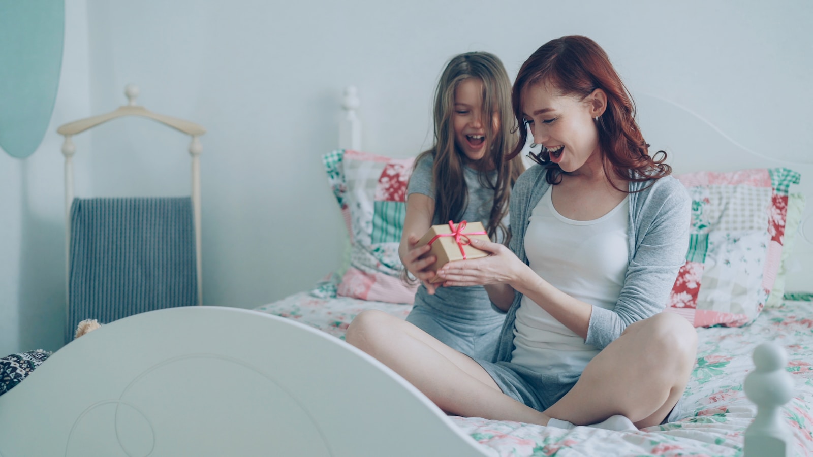 A daughter gives her mother a present.