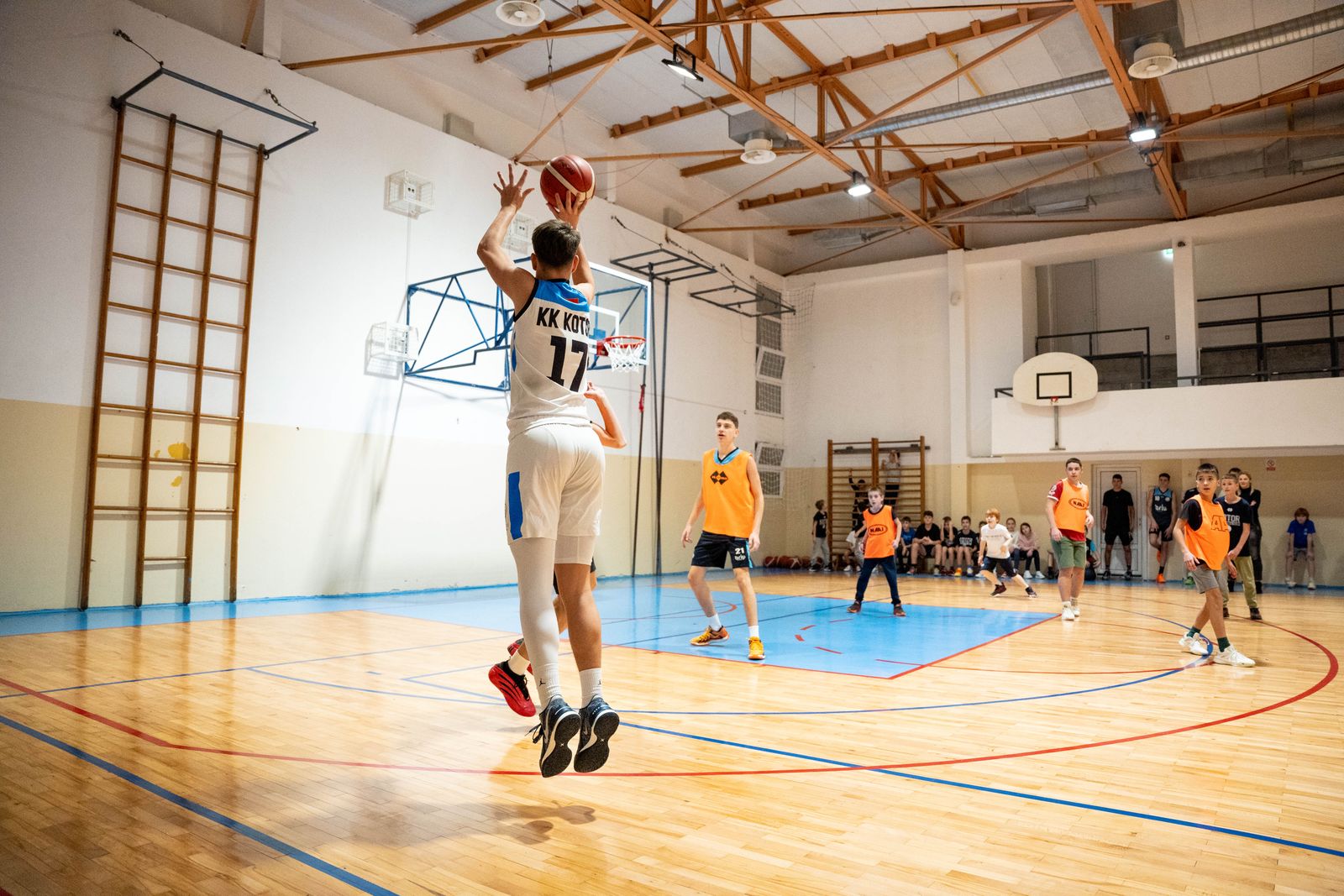 Exciting moment from a basketball game with players in action on an indoor court.