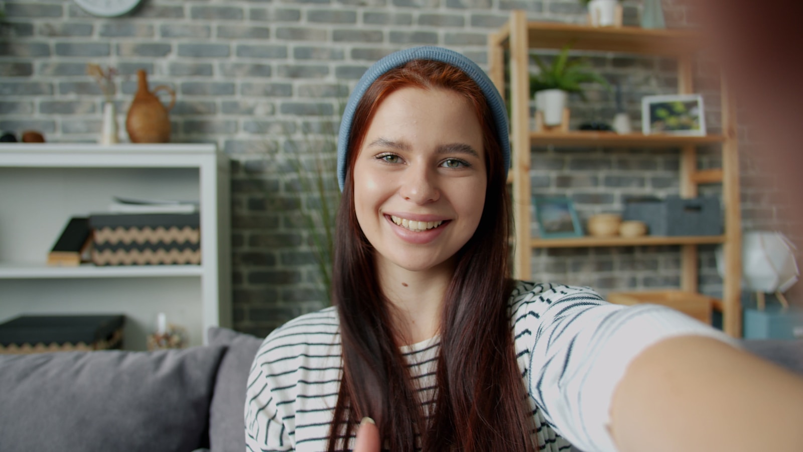 Young woman with red hair taking a selfie