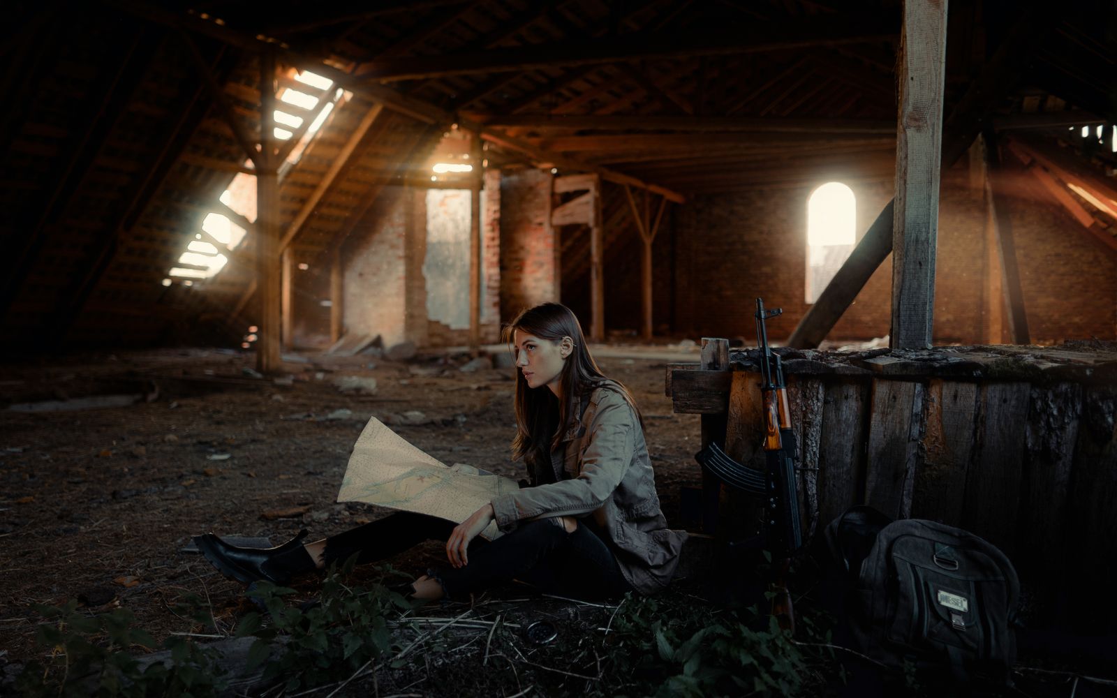 Woman with a map in an abandoned attic, ready for adventure. Dramatic light creates a mysterious atmosphere.