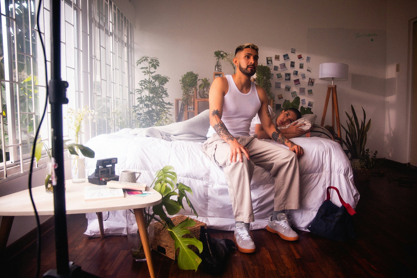 a man sitting on top of a bed next to a woman