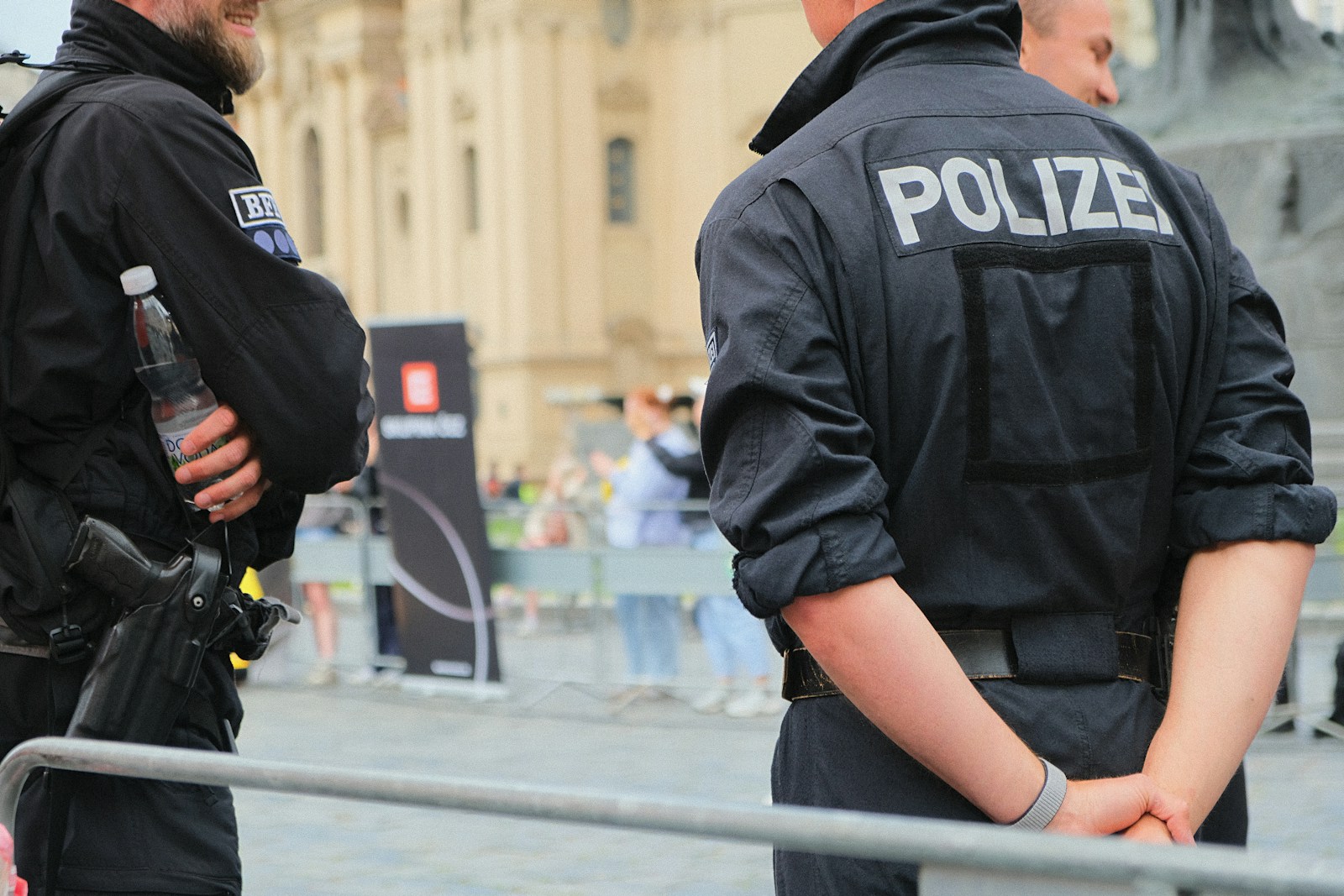 German police officers stand guard in public.
