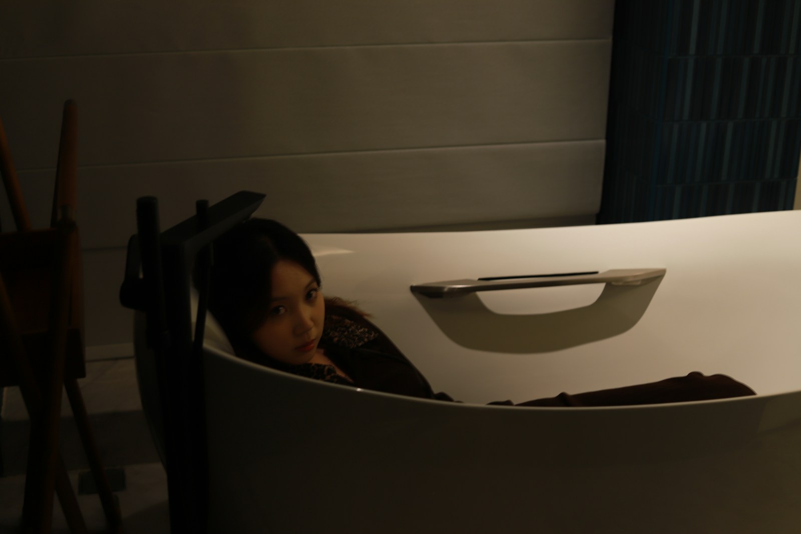 Woman relaxing in a modern bathtub.