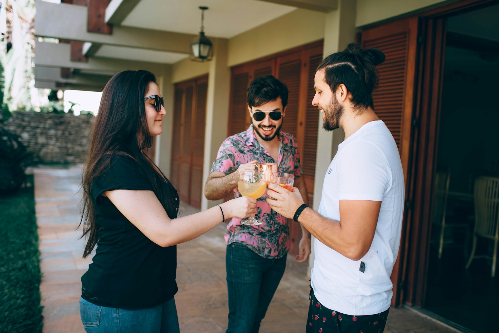 man in white crew neck t-shirt standing beside woman in black tank top