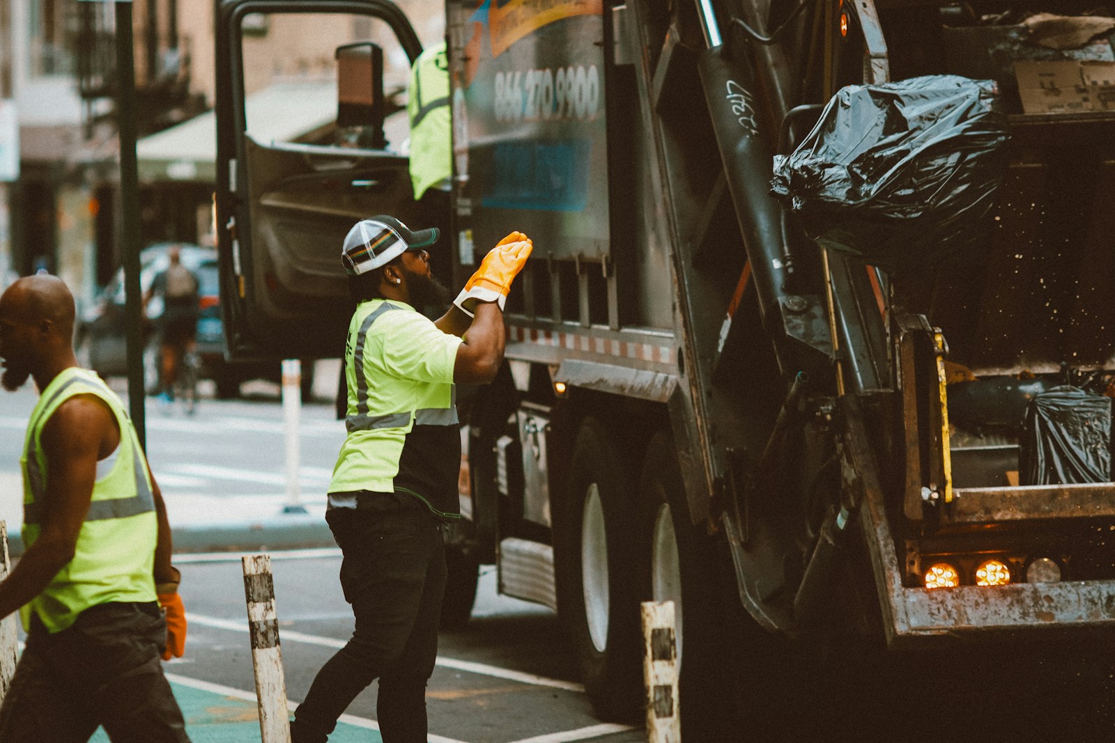 a man in a yellow vest is holding a piece of paper