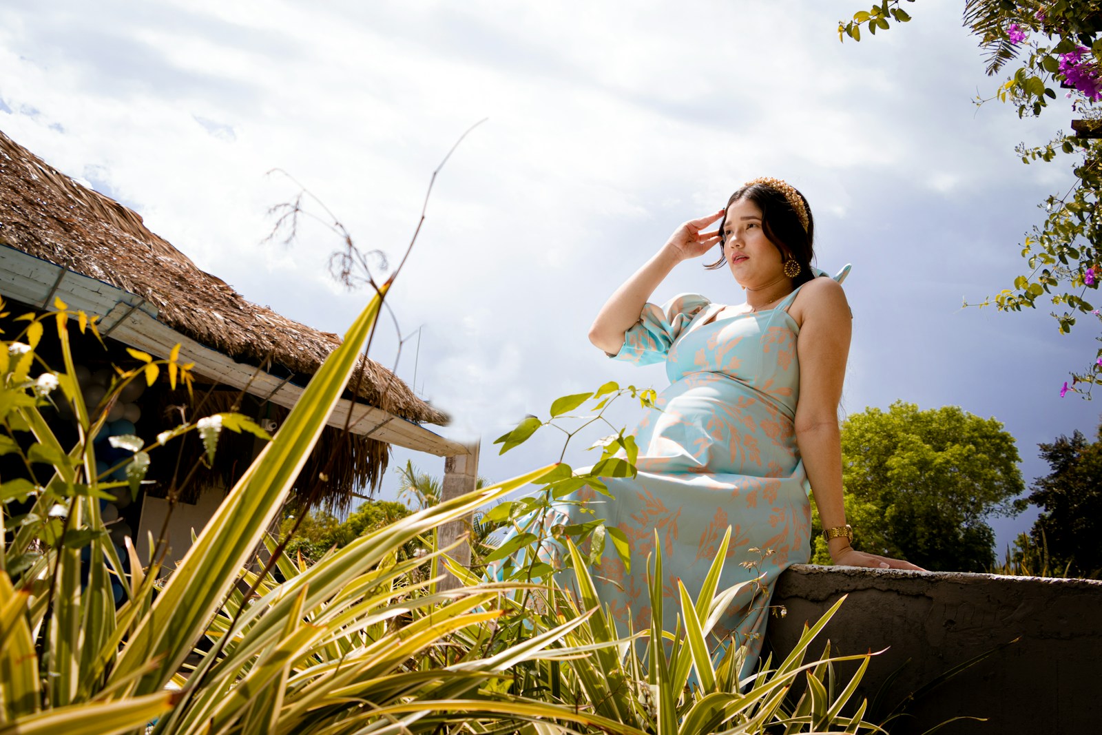 woman in white sleeveless dress standing near green plants during daytime