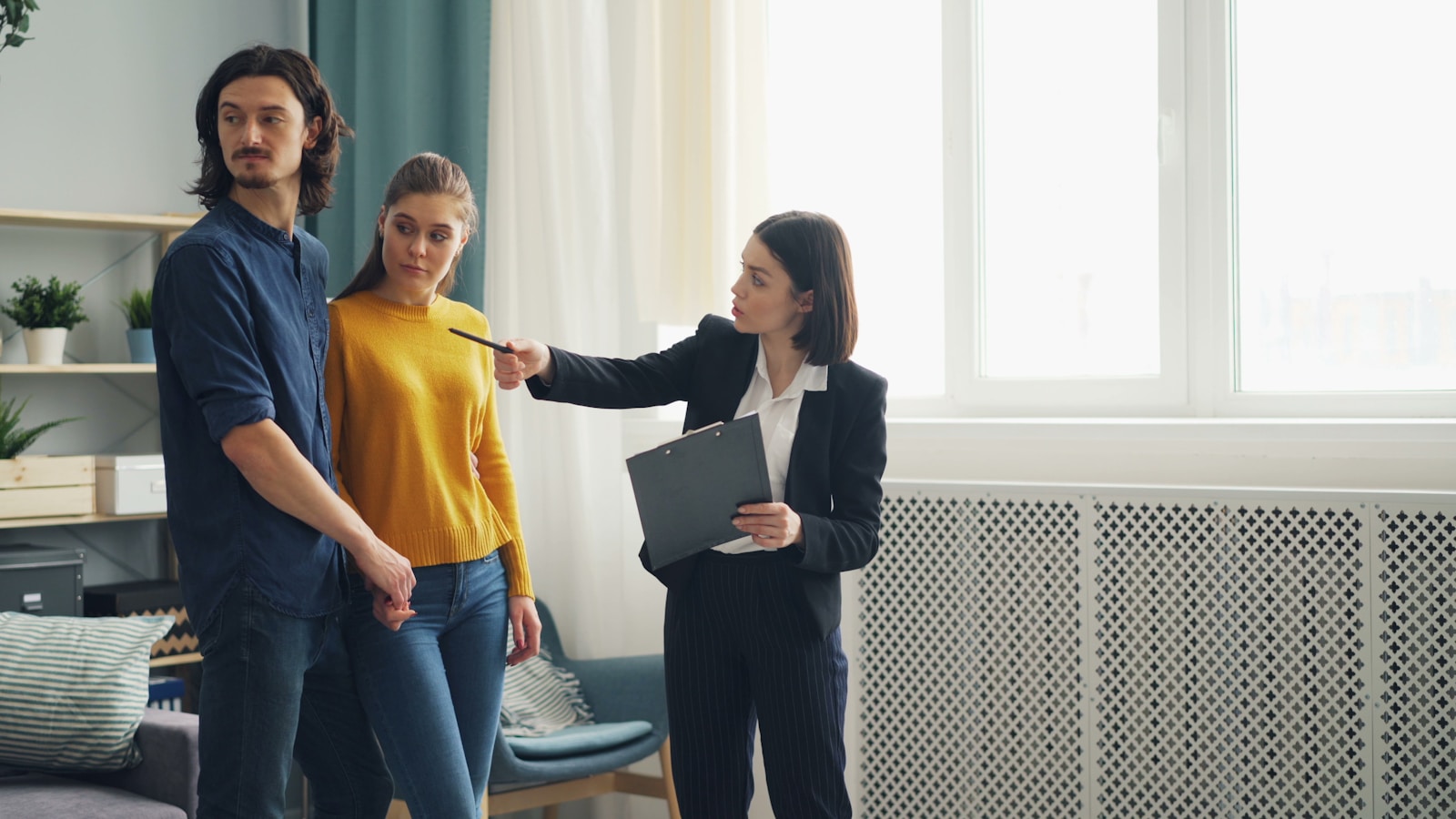 a group of people standing around a living room