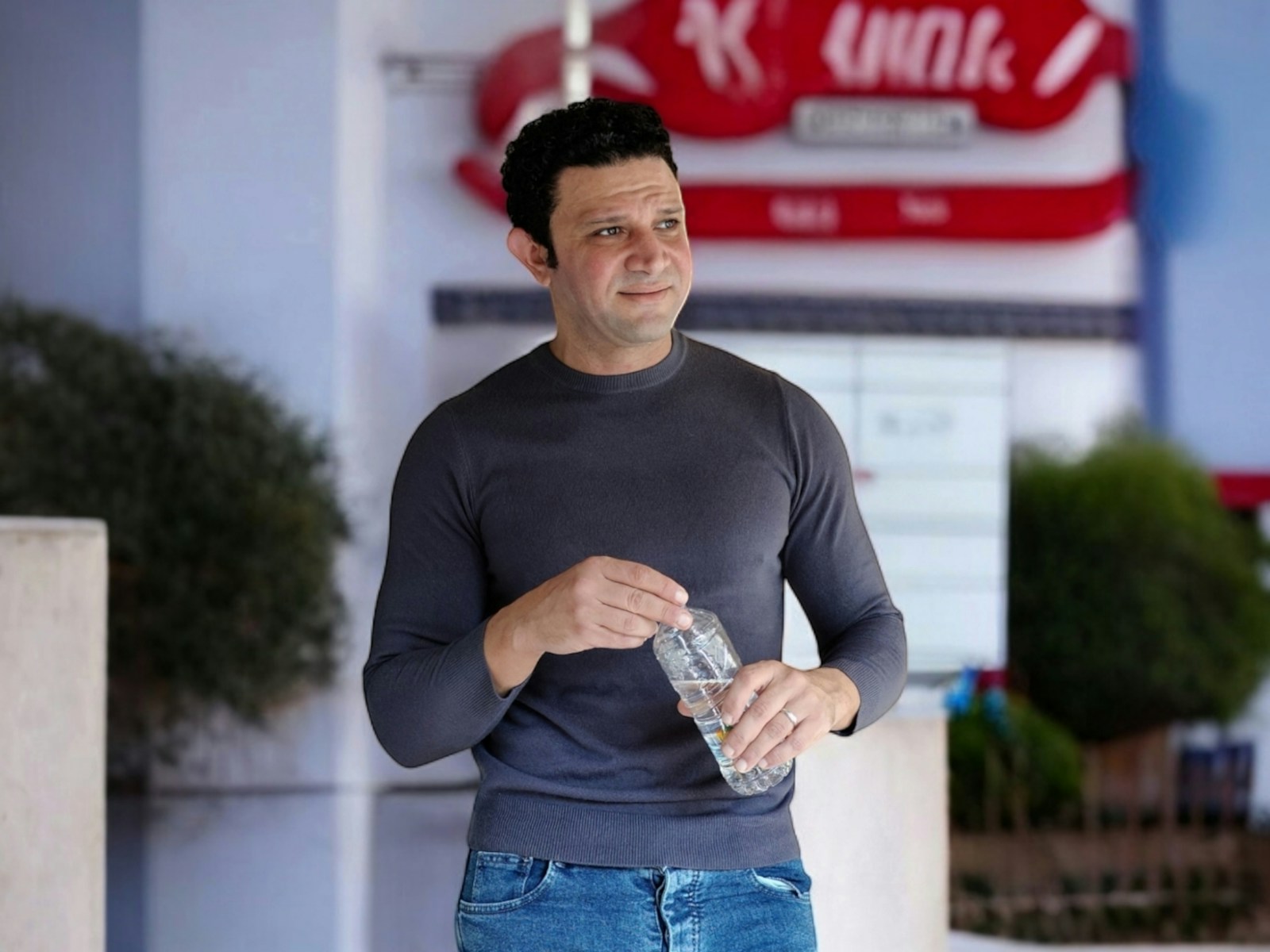 A man holding a bottle of water in his hand