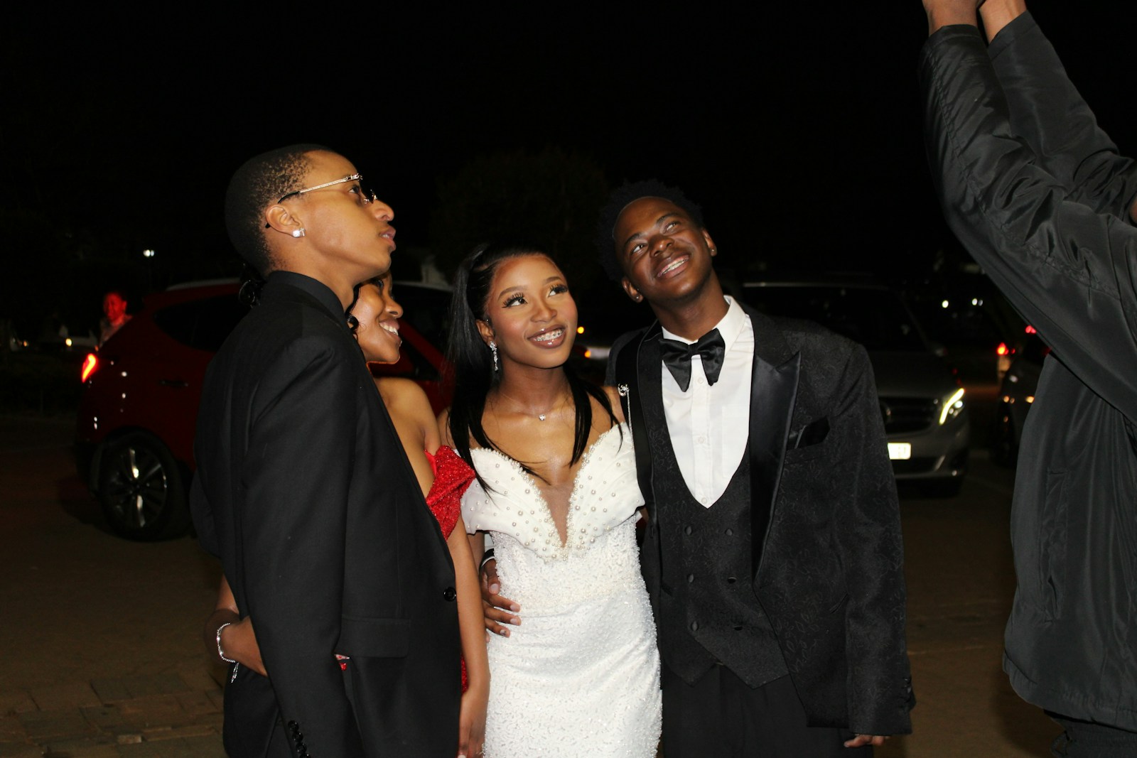 Young people dressed formally at night