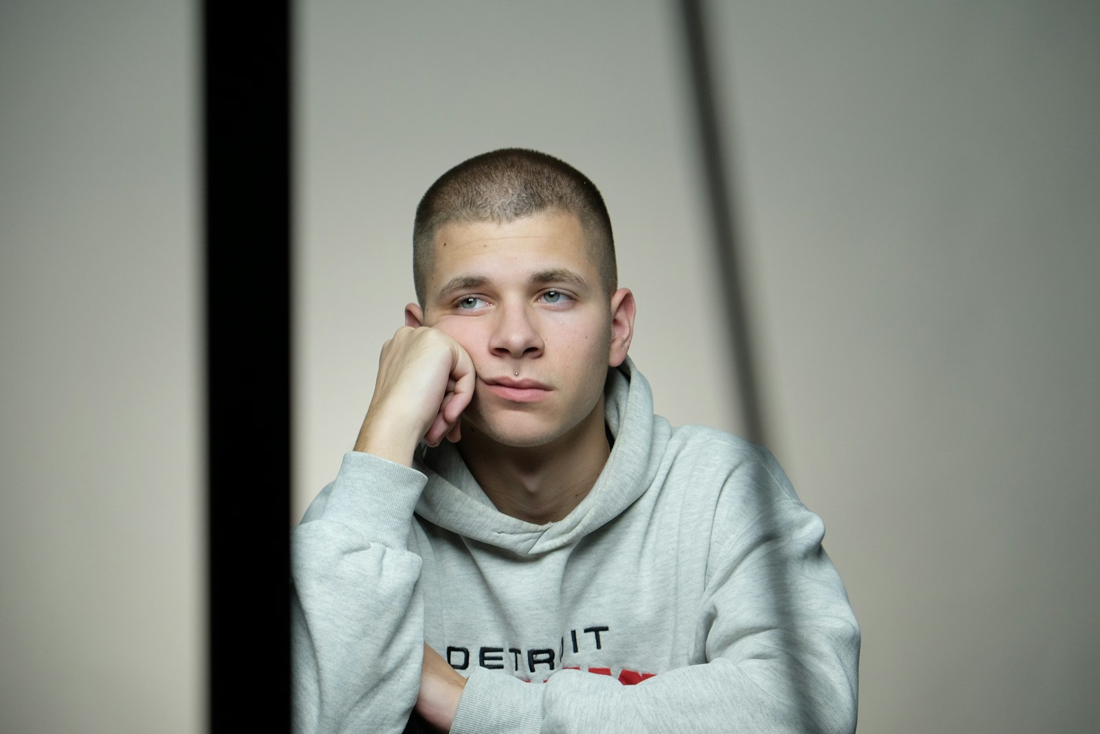 A man sitting at a table with his hand on his chin