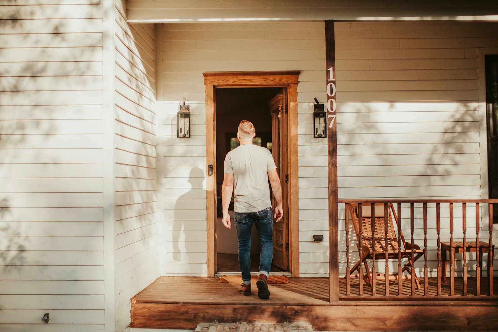 A man standing on the porch of a house