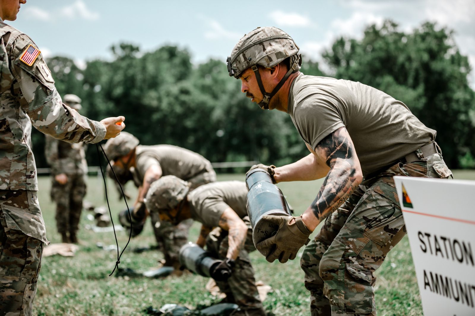 US Army soldiers engage in a rigorous outdoor training exercise at Fort Benning, demonstrating teamwork and discipline.