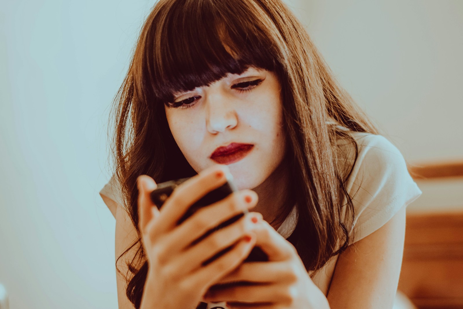 A young girl looking at her cell phone