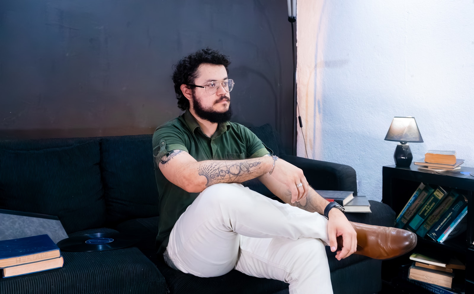Man sitting on a sofa with legs crossed.