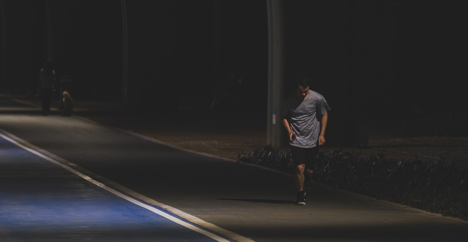 A man walking down a street at night