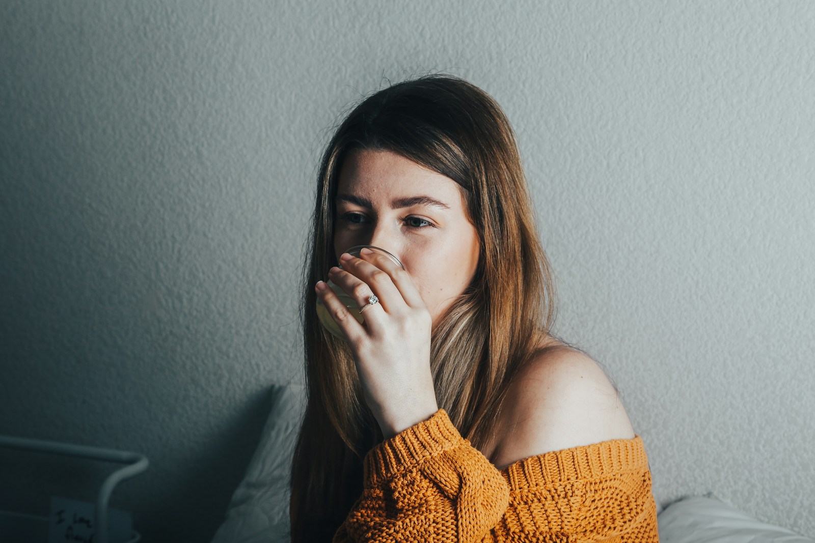 a woman covers her mouth with her hand