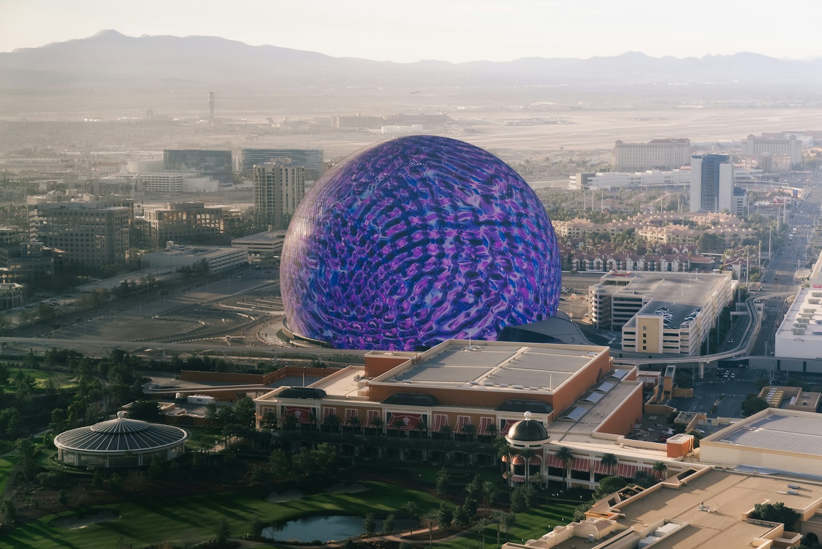 Large purple dome structure in a city landscape