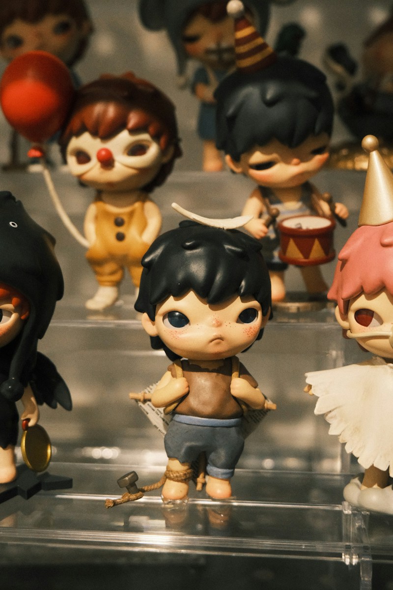 Collection of creepy cute dolls displayed on shelves