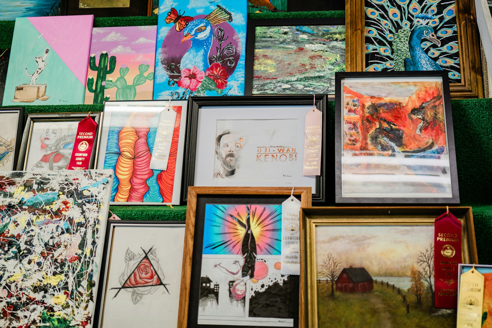 a bunch of paintings and pictures on a wall