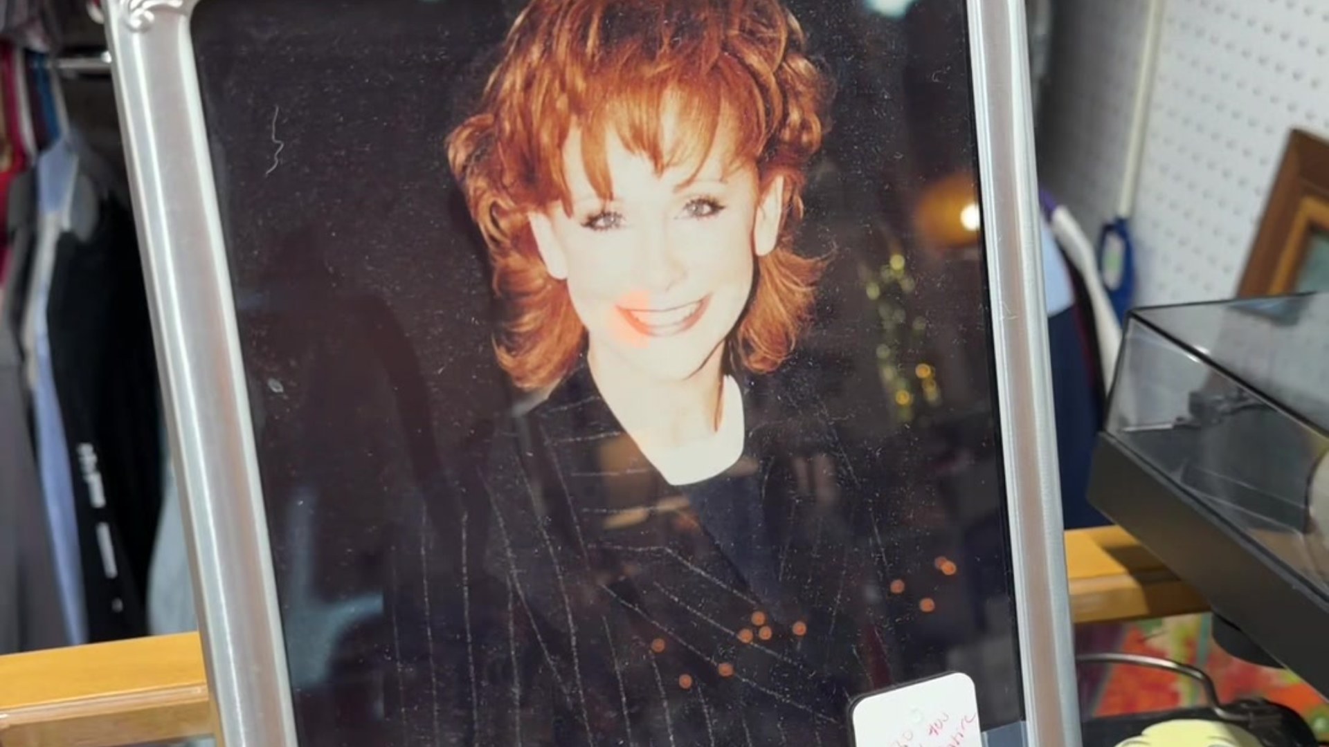 Framed photo of Reba McEntire in an antique store display case