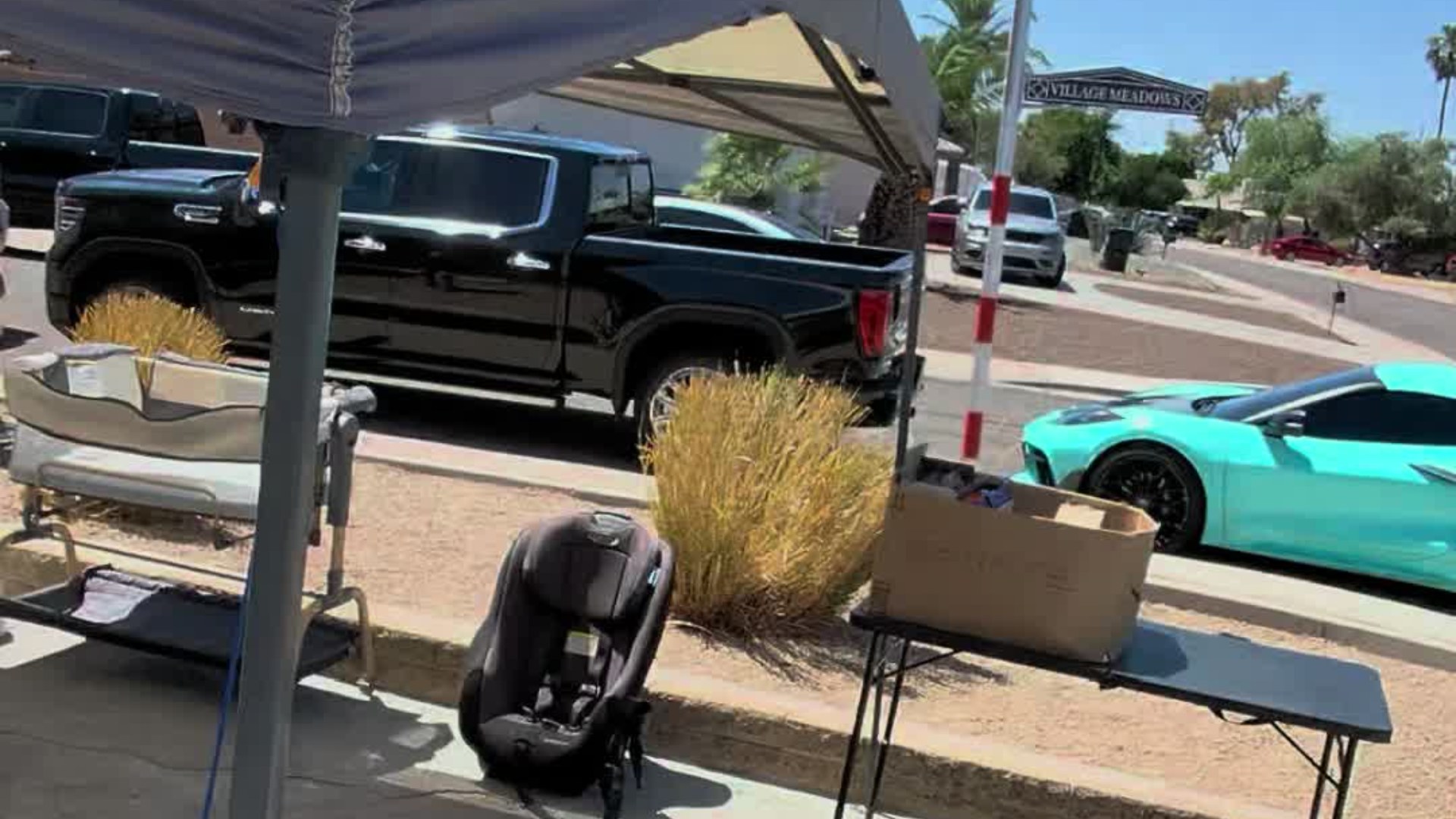 Driveway yard sale tables under a canopy tent