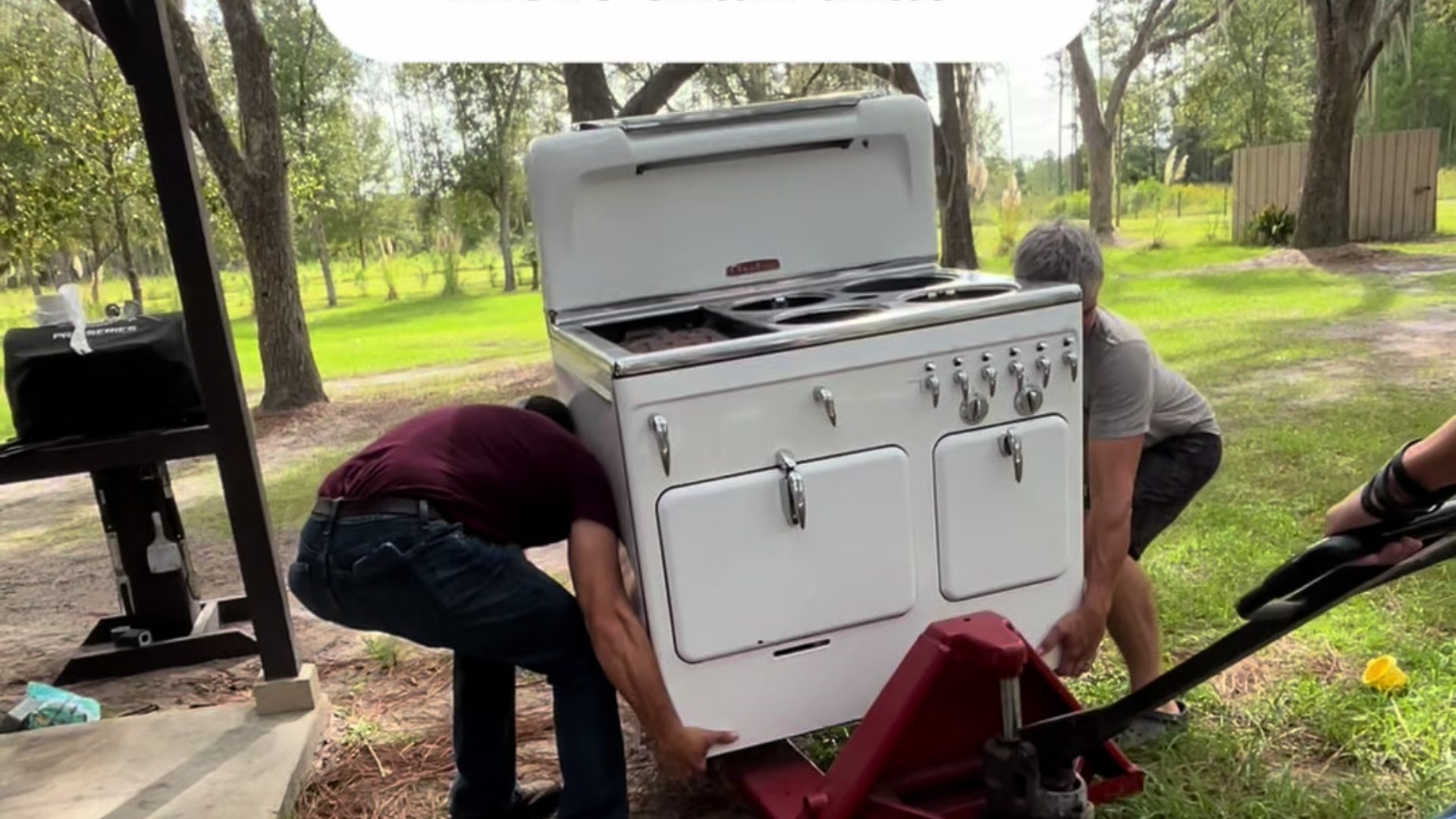 Vintage Chambers stove being moved on a dolly outdoors