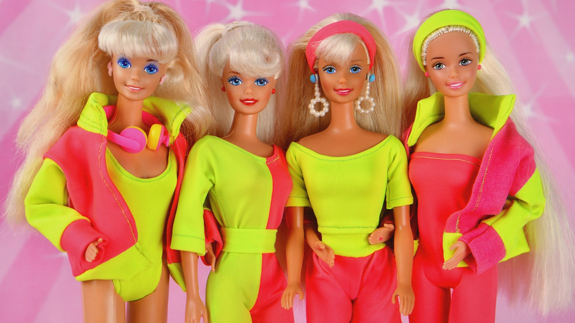 Four 1980s Barbie dolls in neon outfits