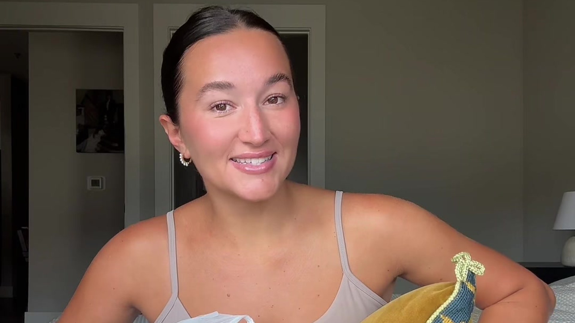 Creator Kylie Witt smiling at the camera with estate sale finds after fighting through a crowd of 200 shoppers
