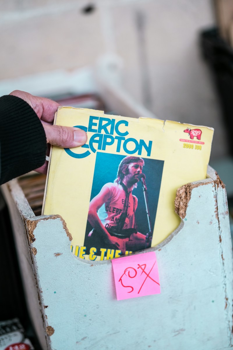 a person holding a record in their left hand