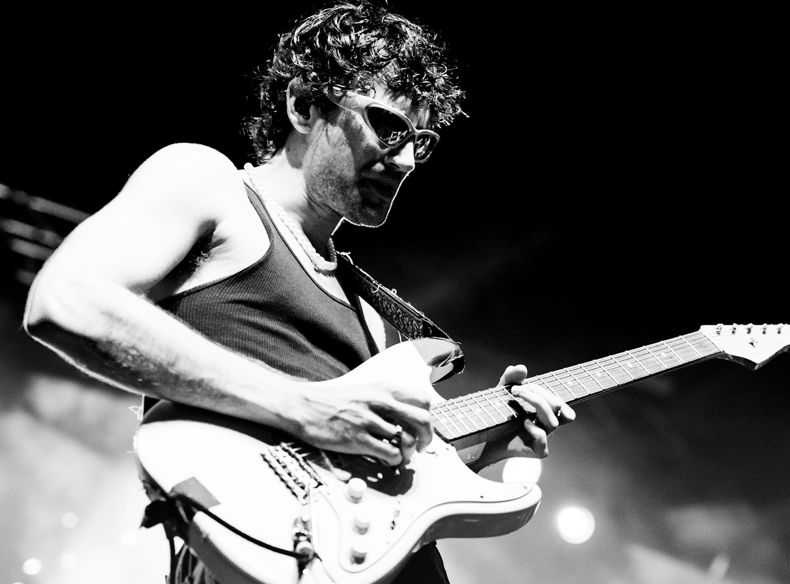 a man playing a guitar on stage at a concert