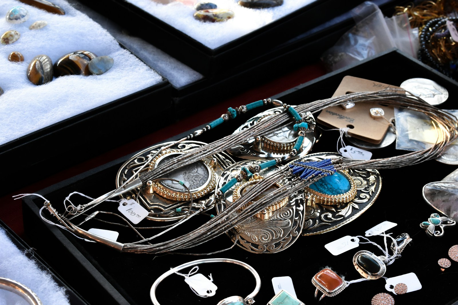 silver-colored jewelries on black case