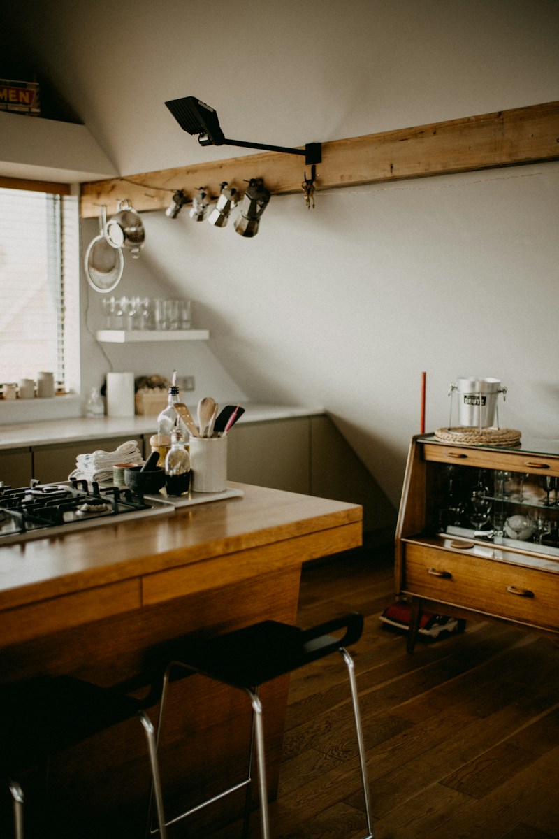 Modern kitchen island with stools and cooking utensils