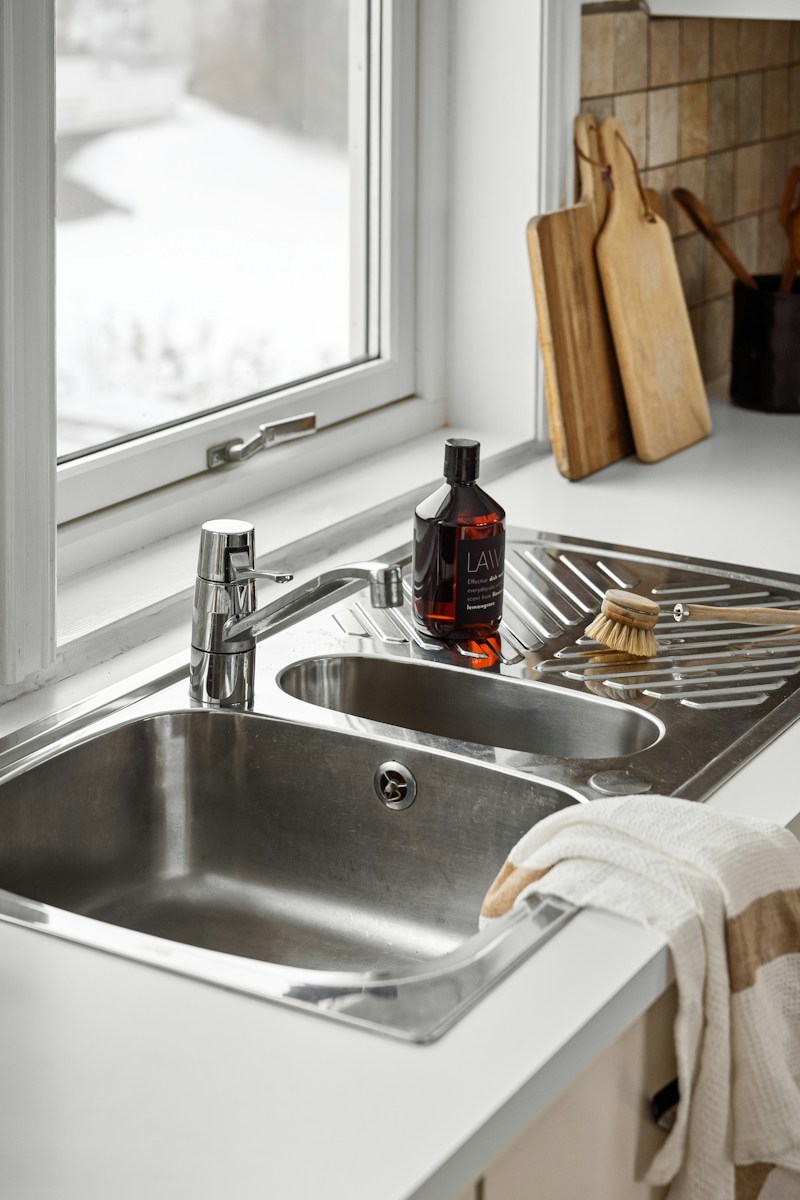 A kitchen with a sink and a window