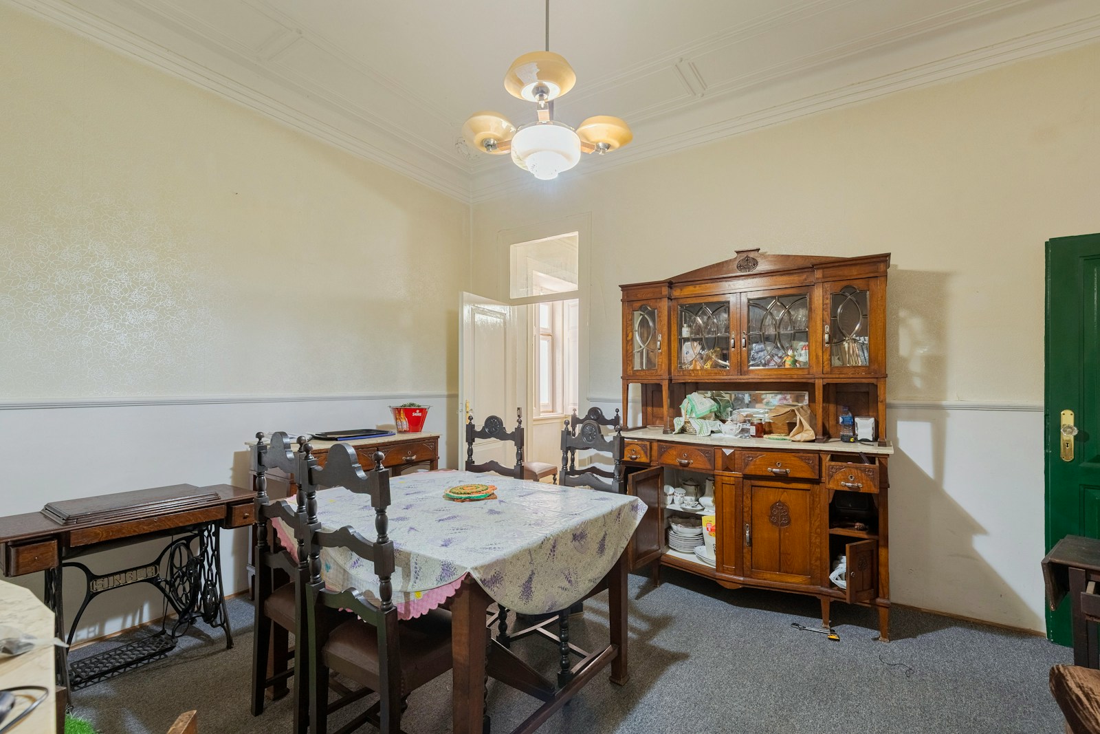 Dining room with vintage furniture and a sewing machine