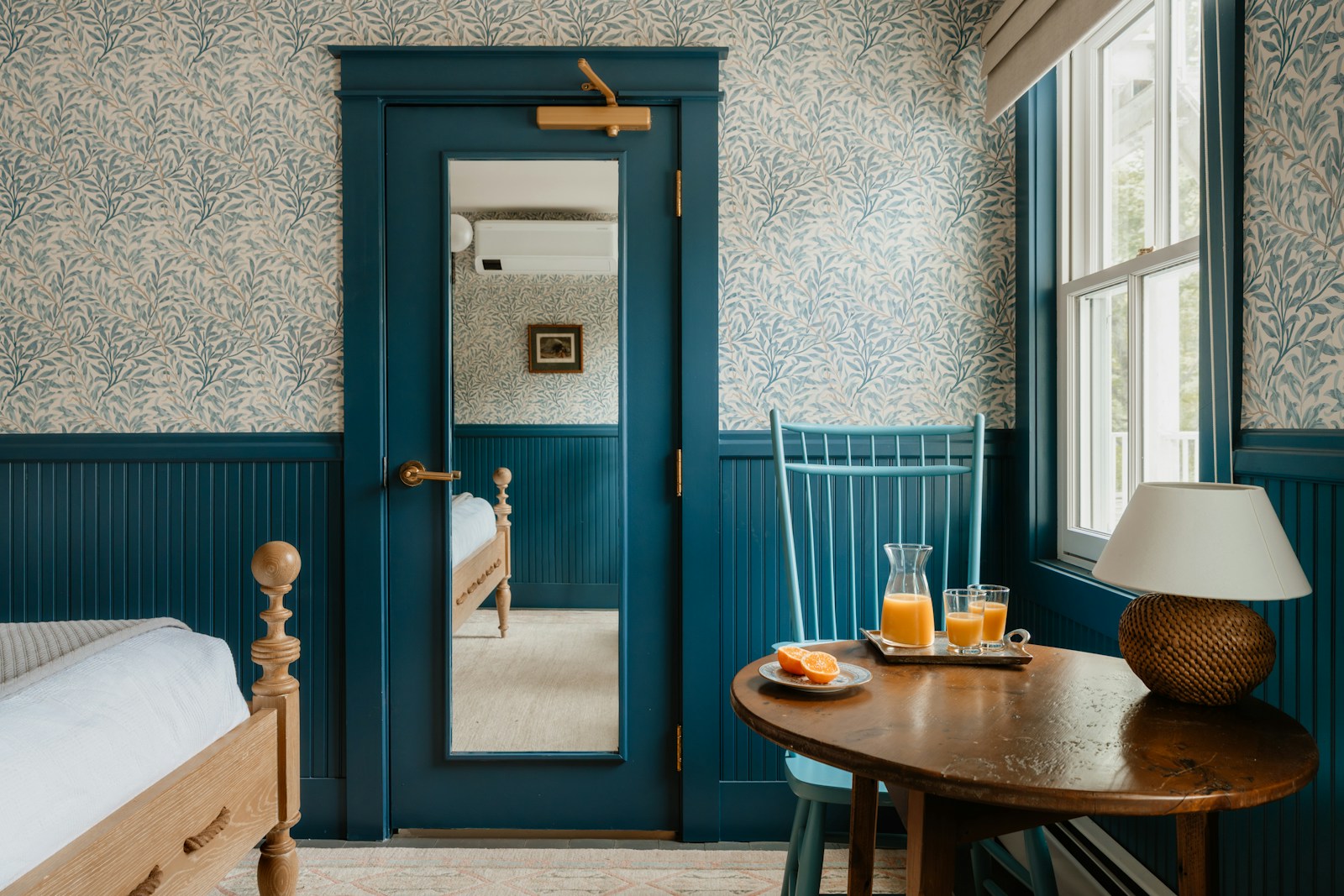 A cozy bedroom has drinks on a table