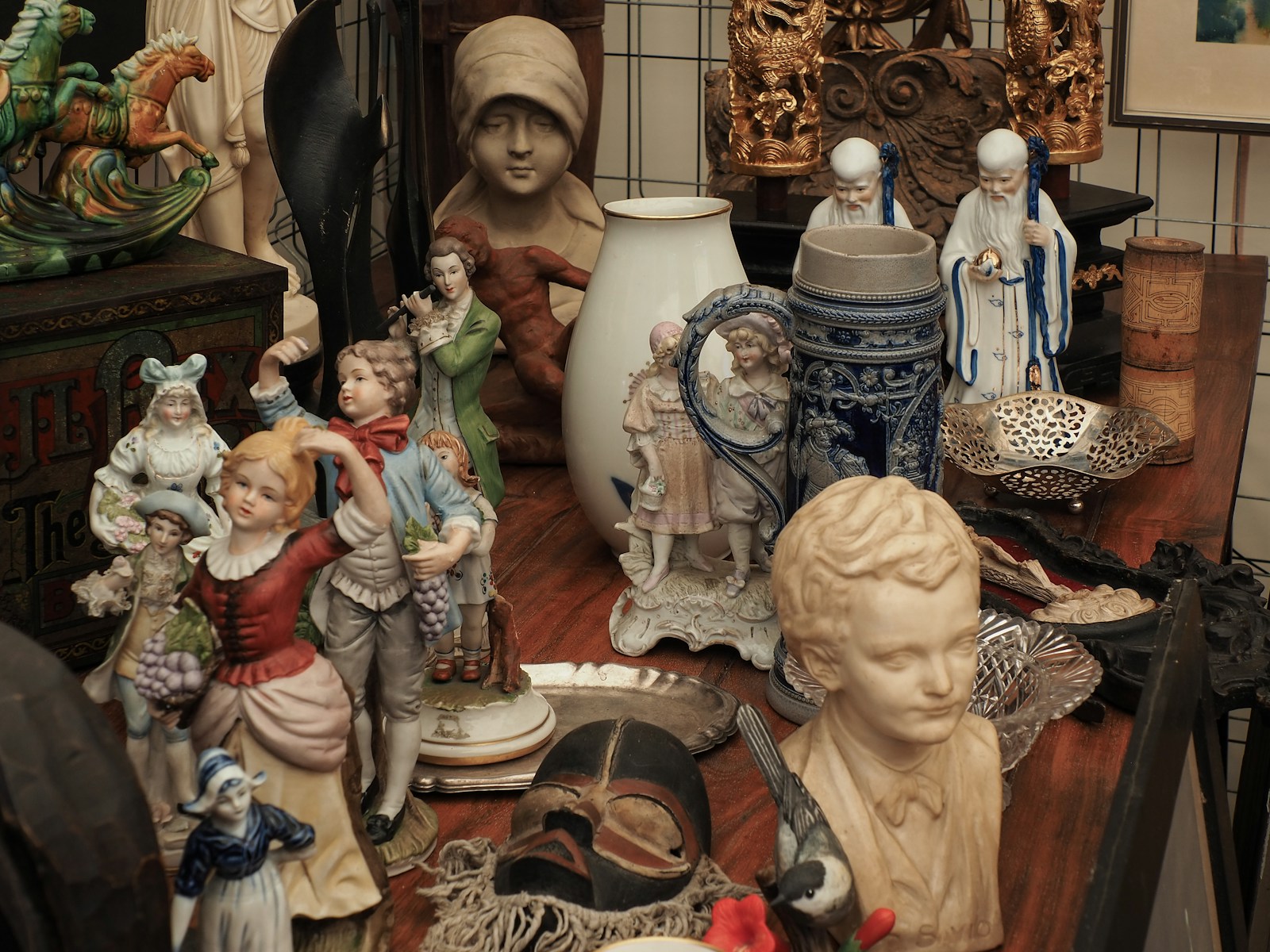 a table topped with lots of figurines on top of a wooden table