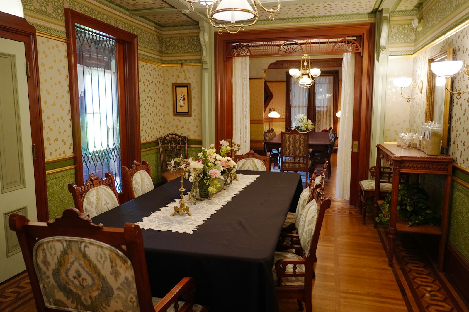 A vintage dining room table is set for a meal